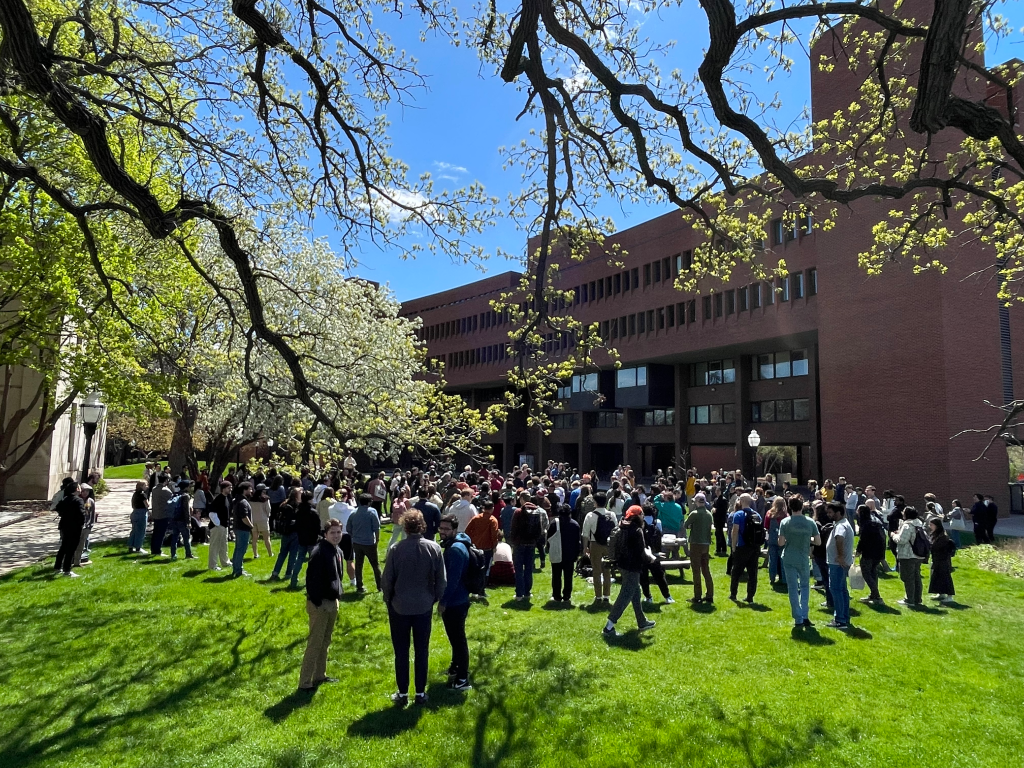 A crowd gathered on a lawn on the East Bank campus to celebrate May Day with GLU-UE. 
